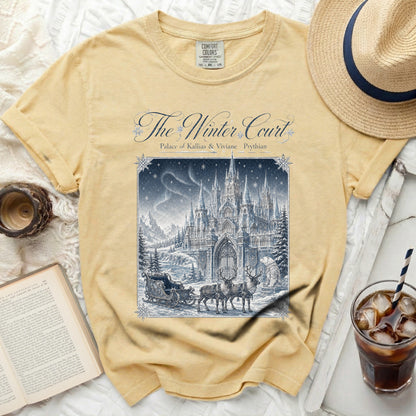 Yellow t-shirt with "The Winter Court" graphic of a castle, sleigh, reindeer, and bear.