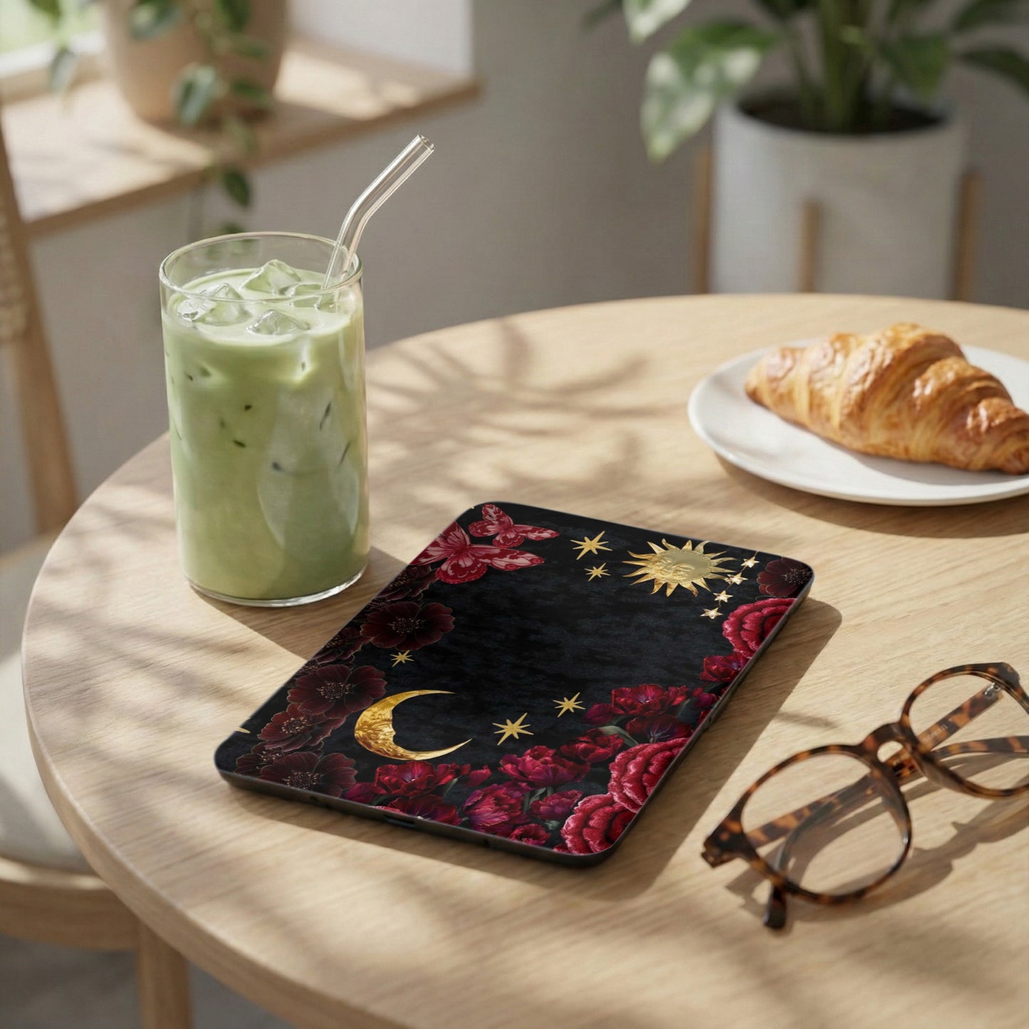Phone case with crescent moon, stars, sun, and floral design.