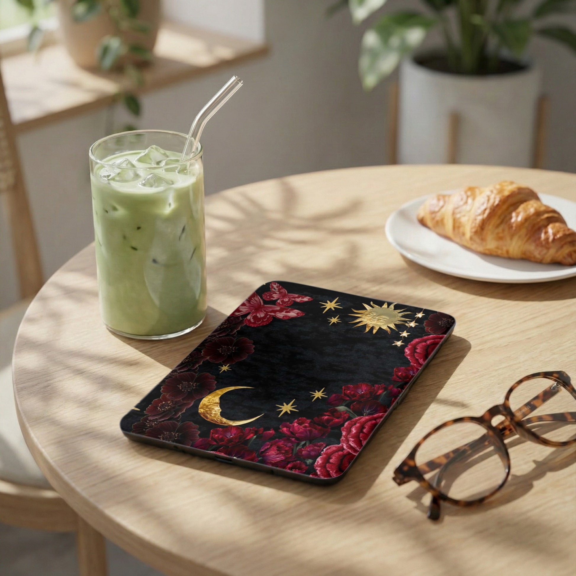 Phone case with crescent moon, stars, sun, and floral design.