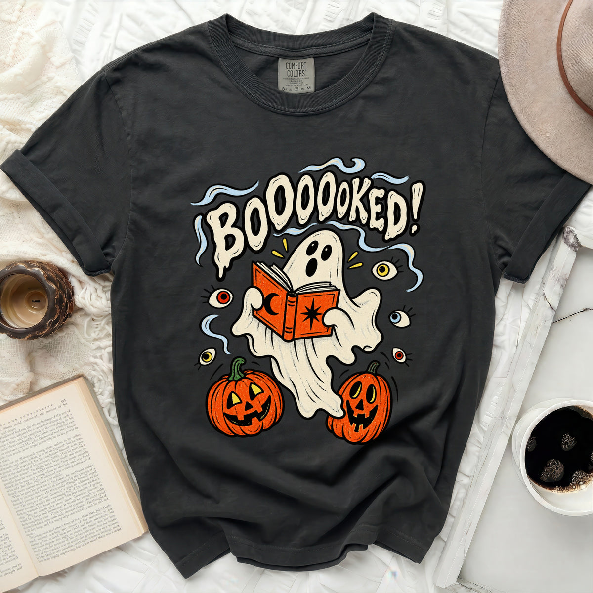 Dark t-shirt with ghost reading book and text "BOOOOOKED!".