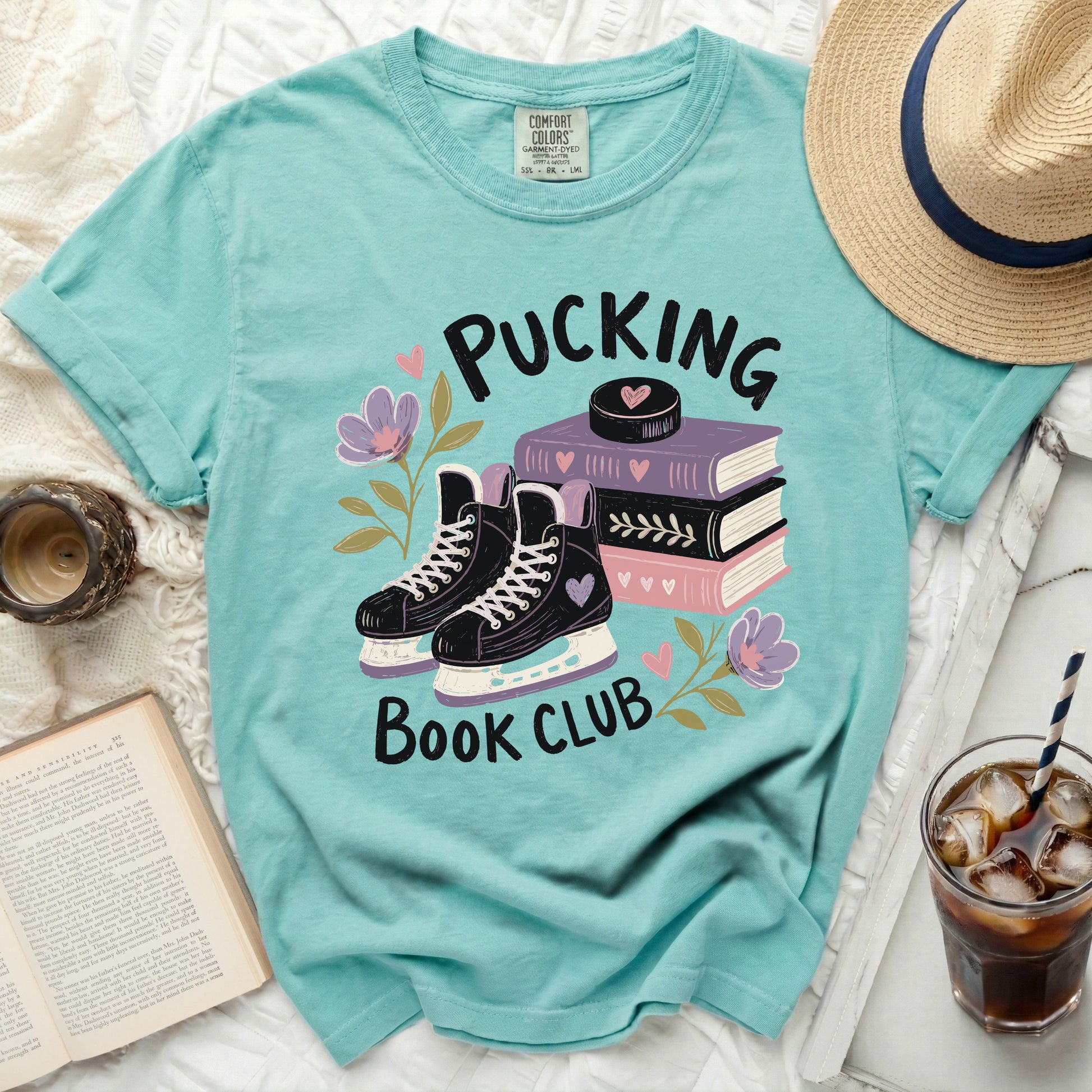 Aqua t-shirt with "Pucking Book Club" text and hockey skates illustration.