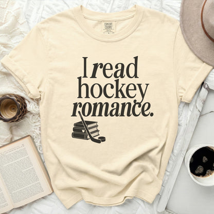 Cream t-shirt with "I read hockey romance" and stacked books graphic.