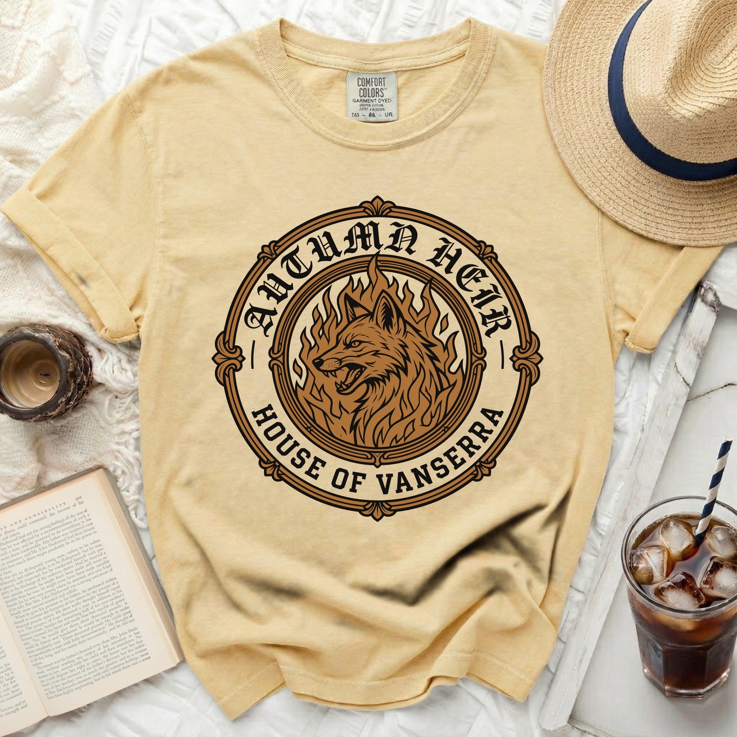 Yellow t-shirt with a circular graphic of a wolf on fire, reading "Autumn Heir House of Vanserra".