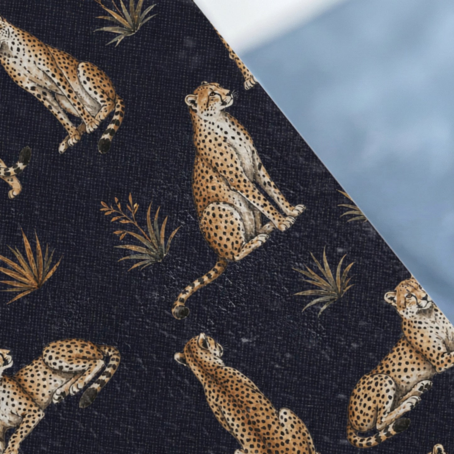 Dark blue fabric with a repeating pattern of cheetahs and palm fronds.