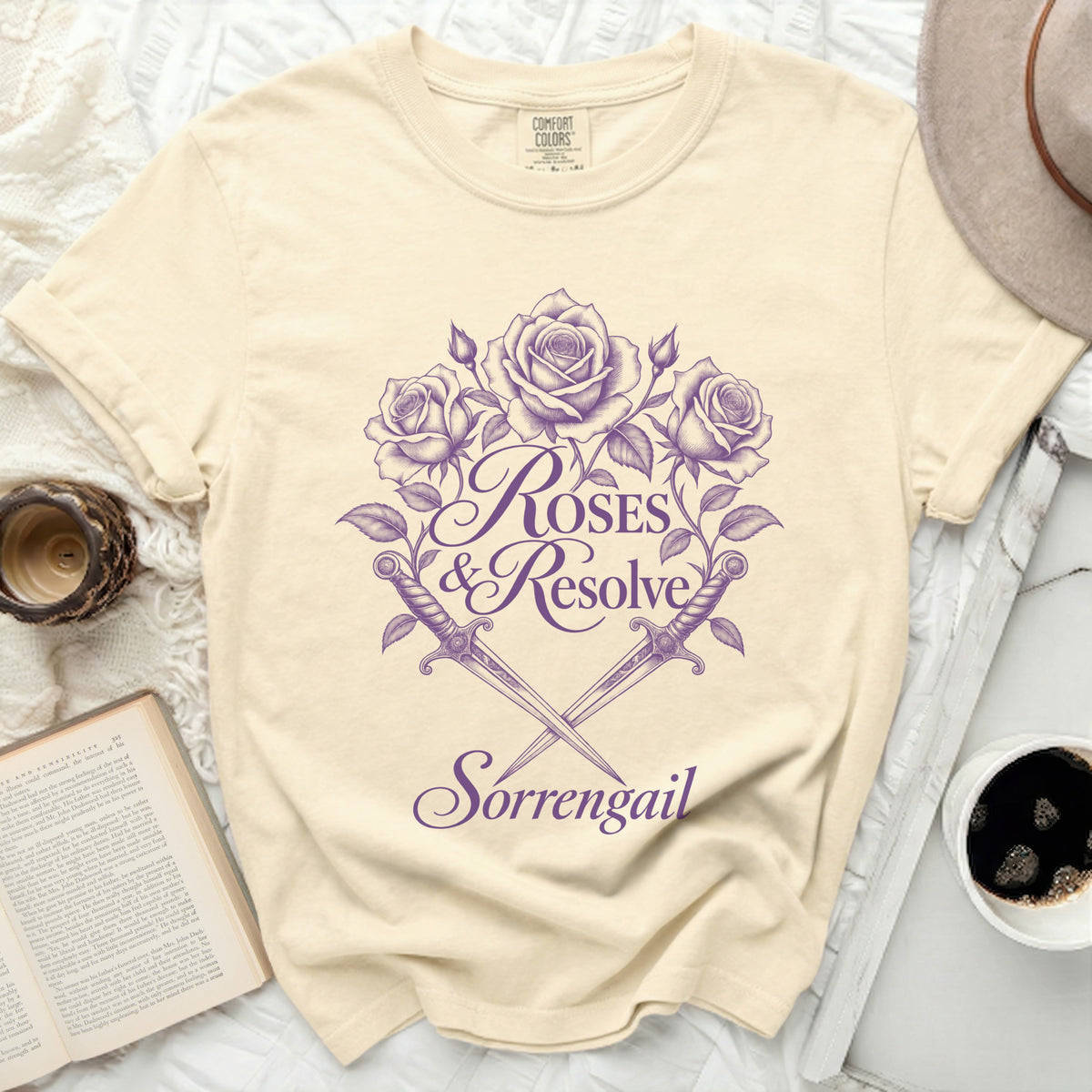 Cream t-shirt with purple roses, swords, and text "ROSES & Resolve Sorrengail".