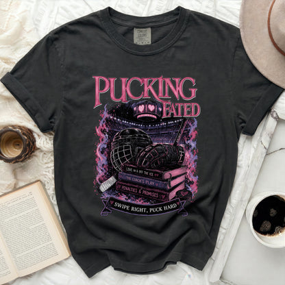 Black t-shirt with "PUCKING FATED" text and hockey graphics.