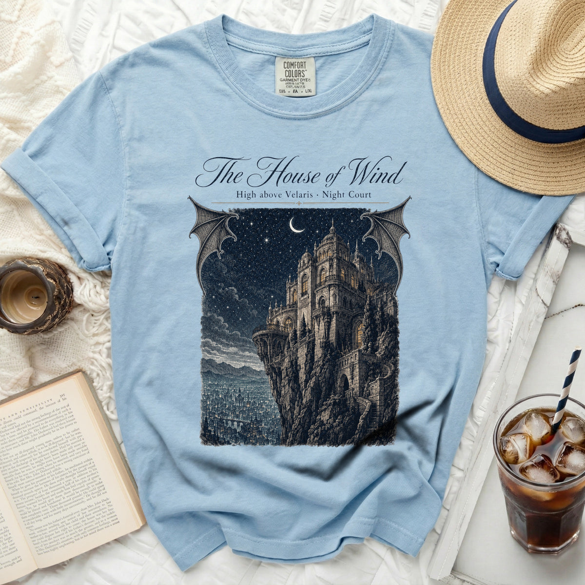 Light blue t-shirt with "The House of Wind, High above Velaris, Night Court" graphic.