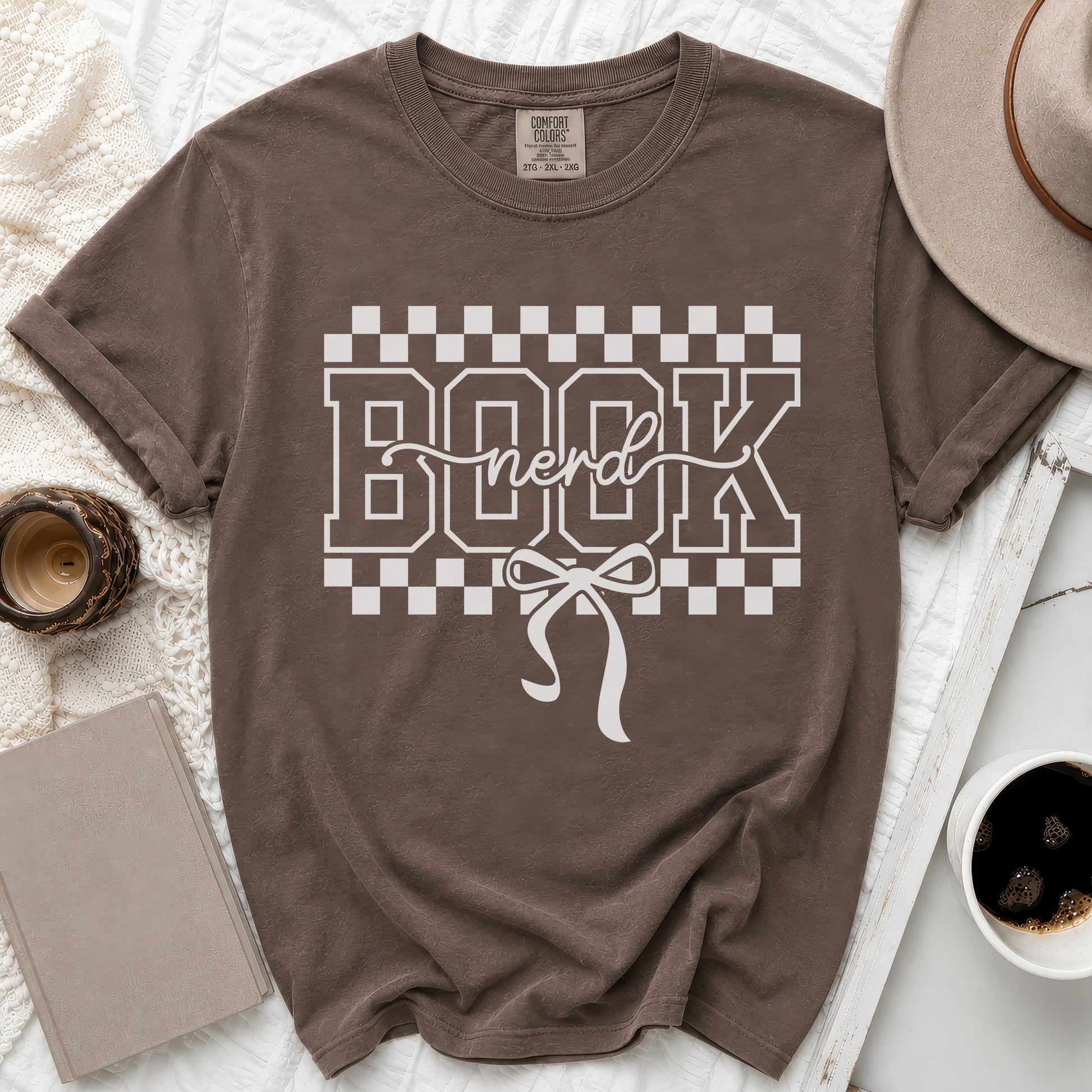 Brown t-shirt with "BOOK nerd" graphic and white ribbon detail.