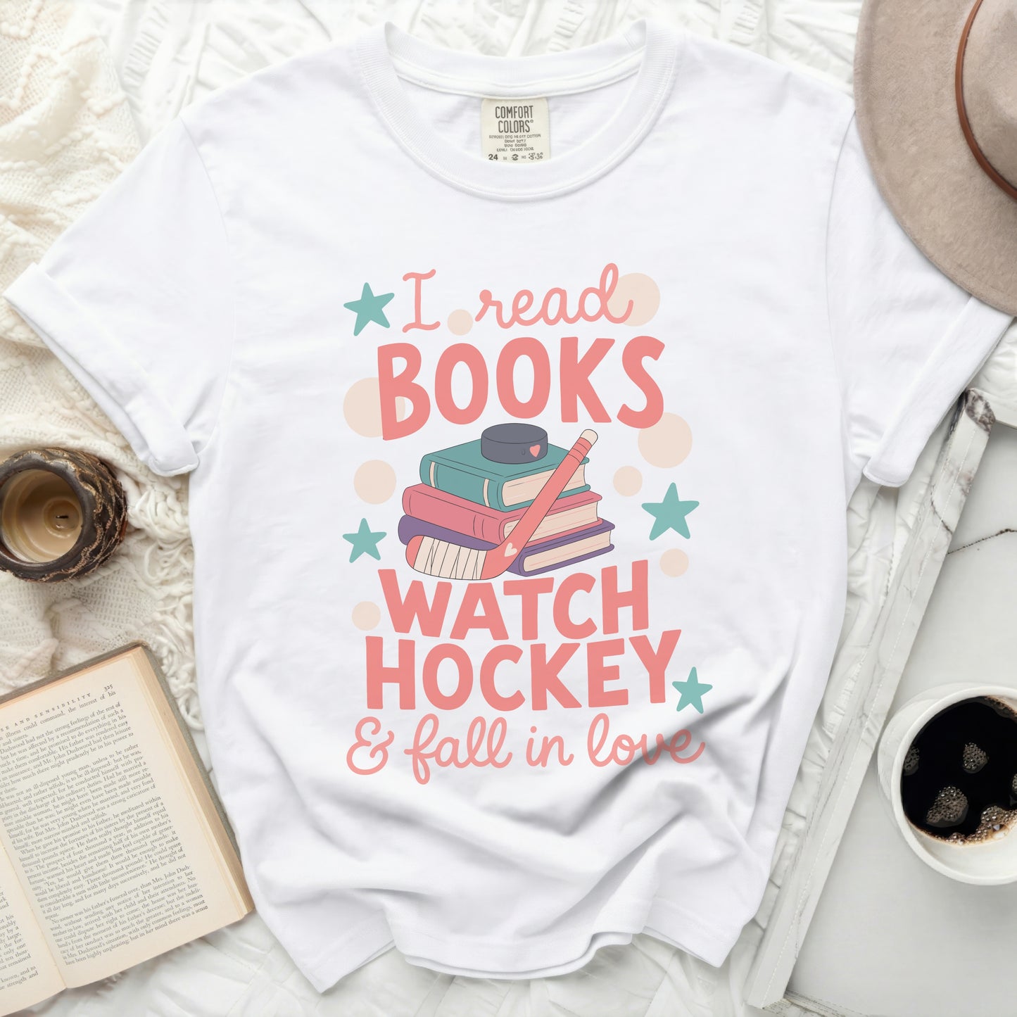 White t-shirt with "I read books, watch hockey & fall in love" graphic.