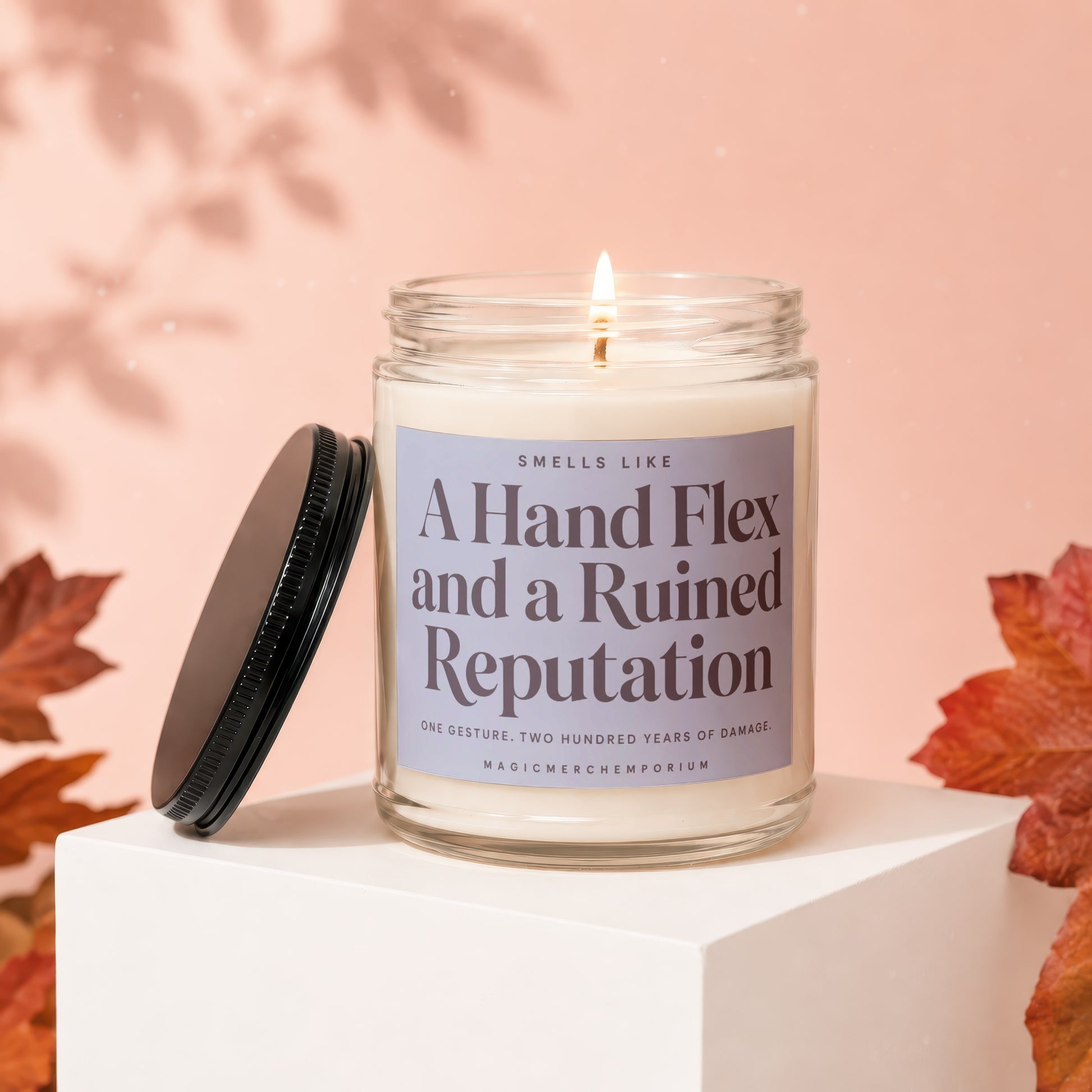 Candle with "A Hand Flex and a Ruined Reputation" label, lid off.