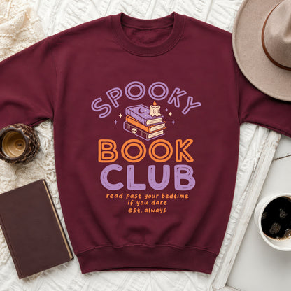 Maroon sweatshirt with "Spooky Book Club" text and stack of books graphic.