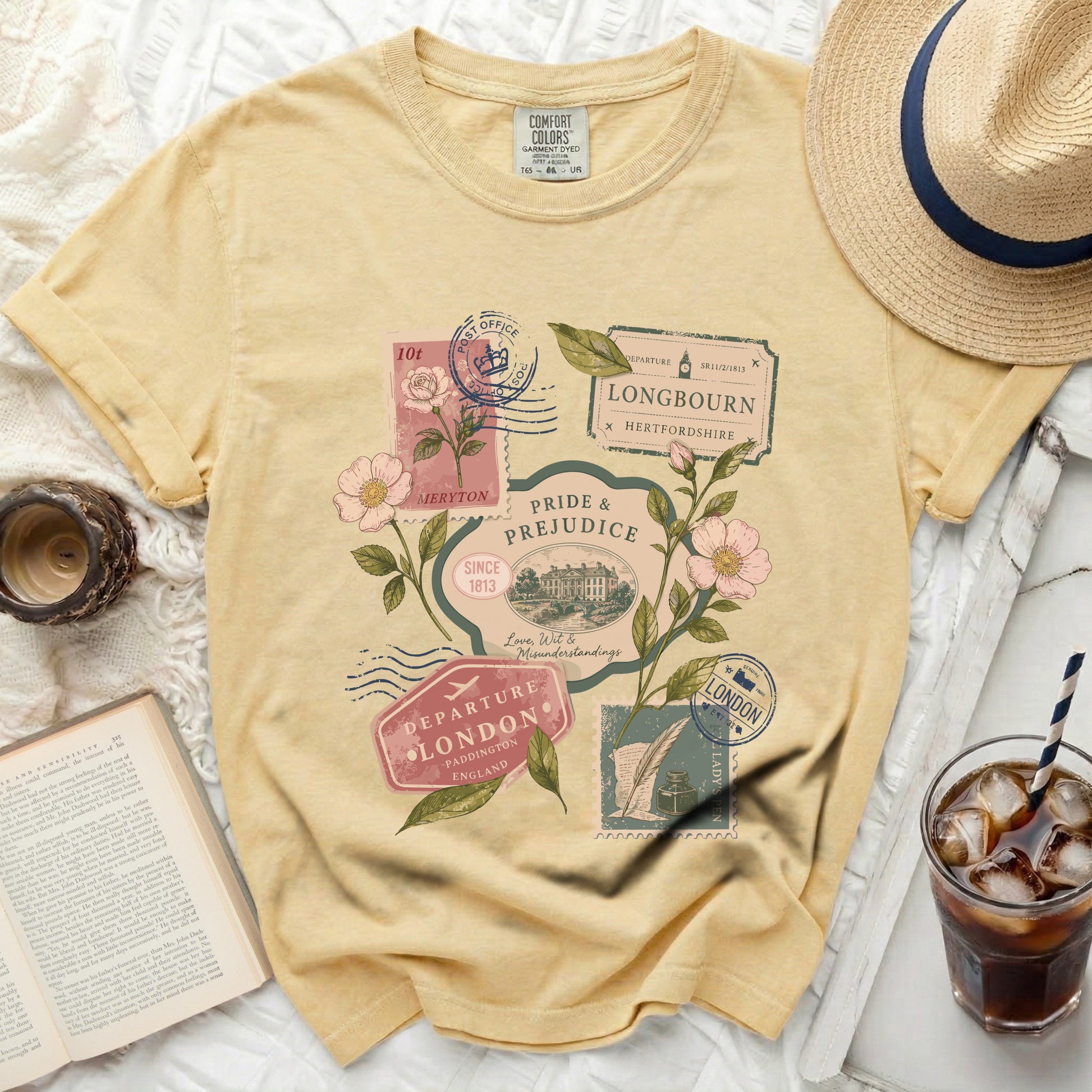Yellow t-shirt with "Pride & Prejudice" graphic and vintage stamps.