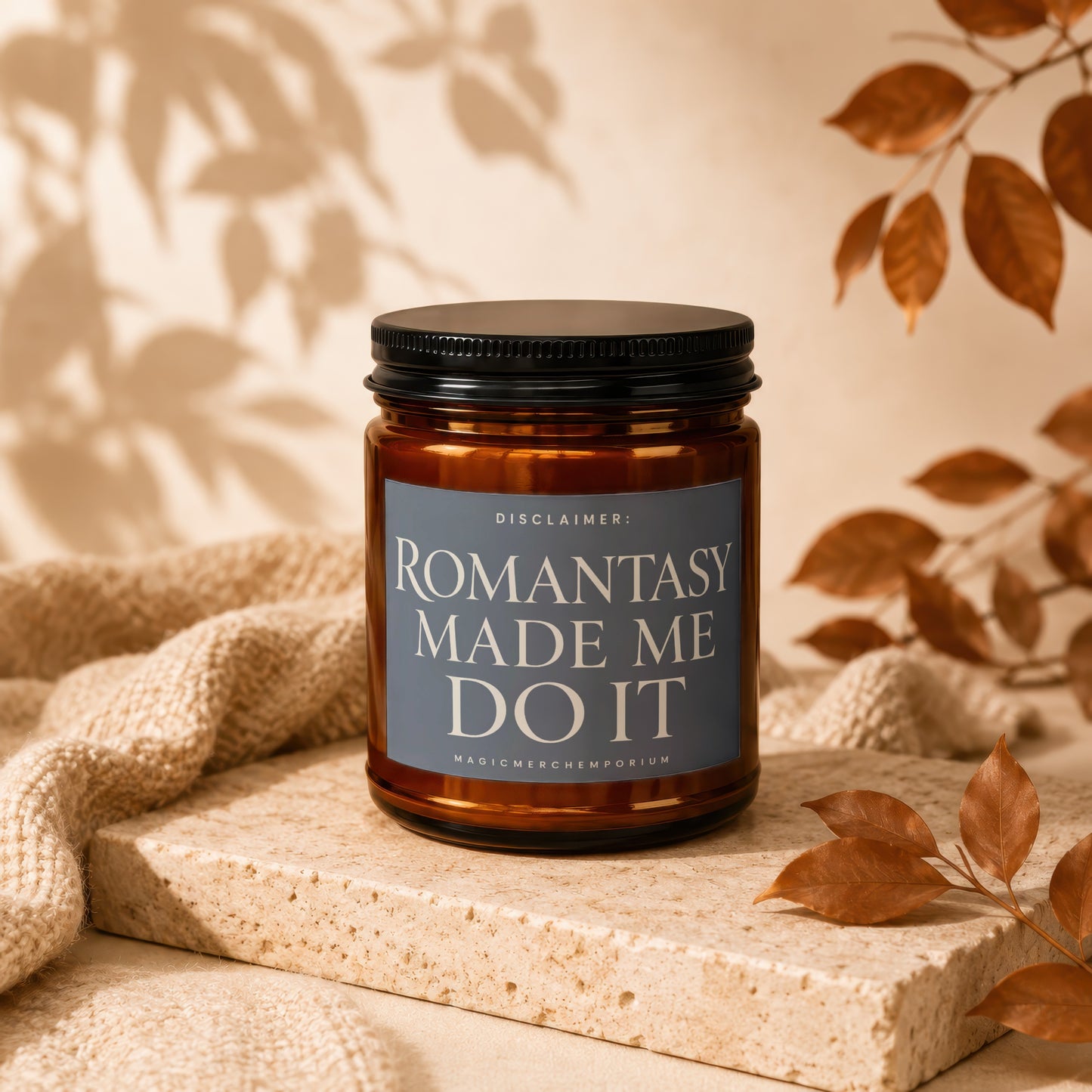 Amber jar candle with black lid reads "ROMANTASY MADE ME DO IT".