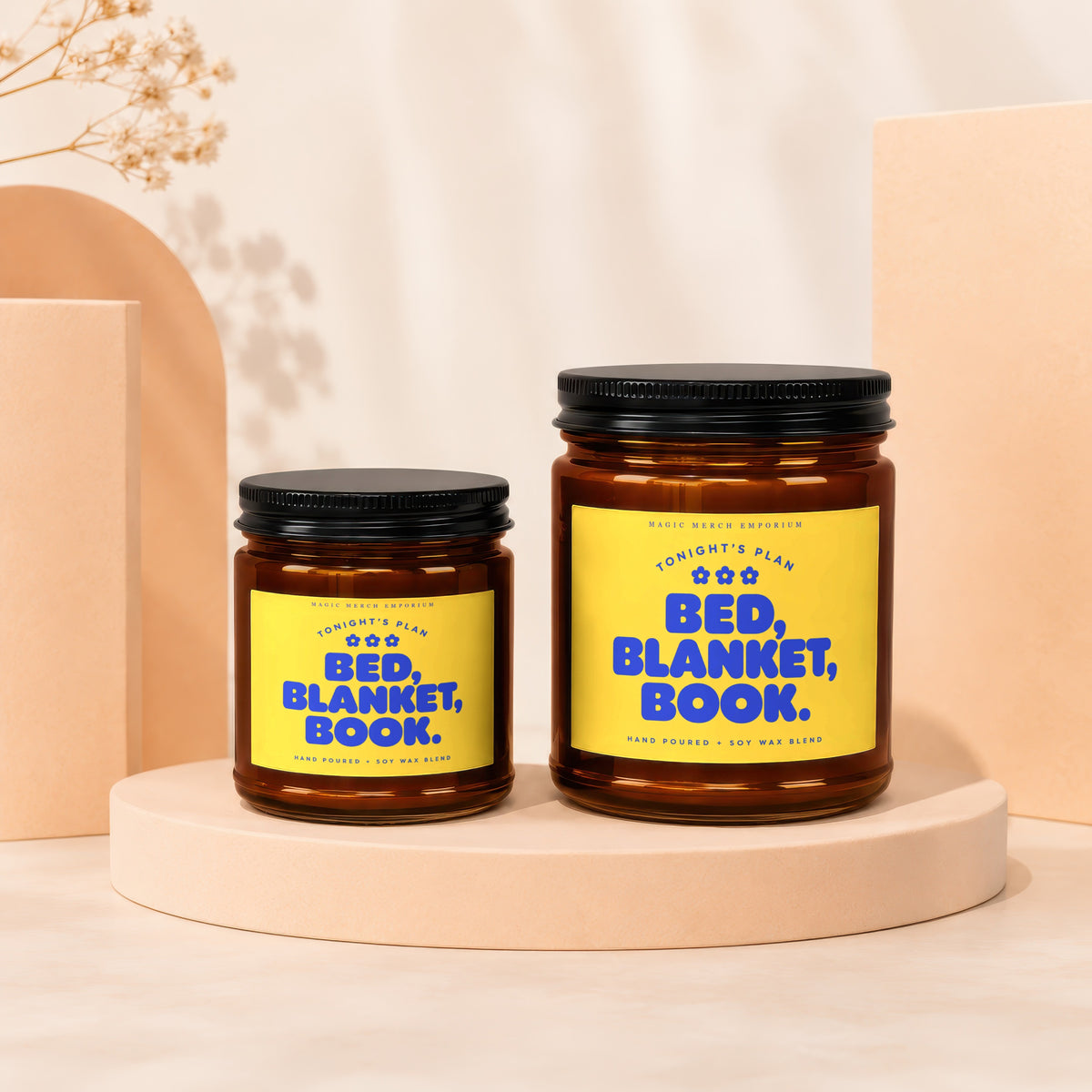 Two amber glass candles with yellow labels reading "Tonight's Plan: Bed, Blanket, Book."