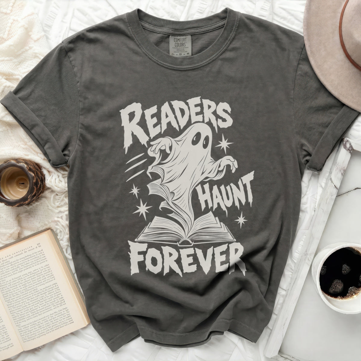 Graphic t-shirt with white text and a ghost rising from an open book.