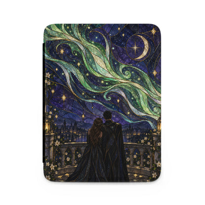 Couple on balcony looking at starry sky with aurora and moon above city.