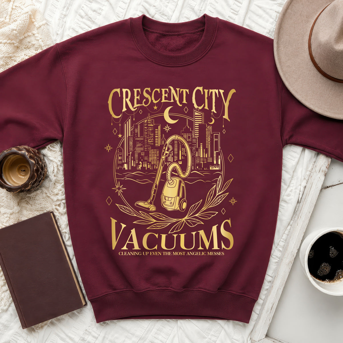 Maroon sweatshirt with gold "Crescent City Vacuums" text and vacuum cleaner graphic.