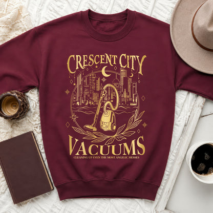 Maroon sweatshirt with gold "Crescent City Vacuums" text and vacuum cleaner graphic.