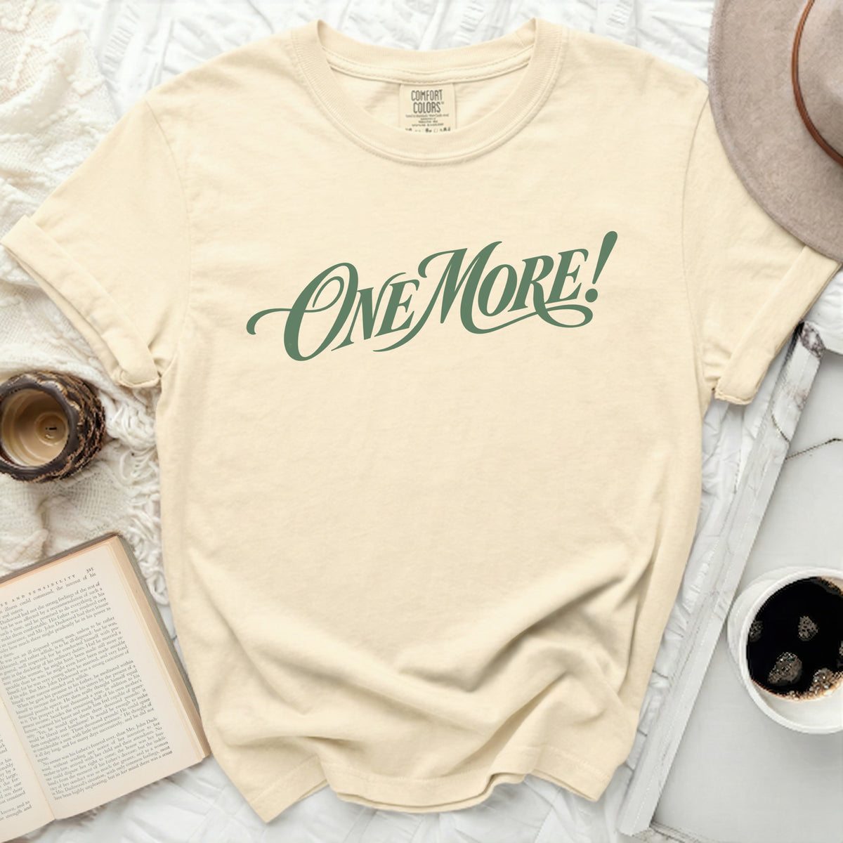 Cream t-shirt with "ONE MORE!" in green script, comfort colors tag.