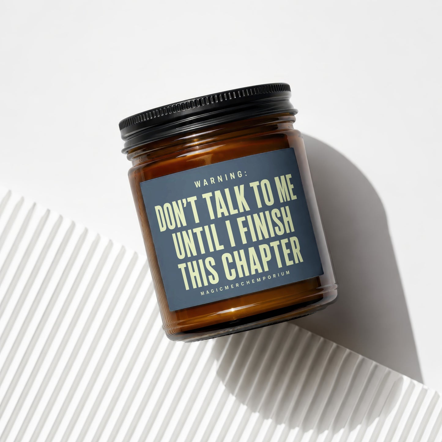 Amber candle with black lid, warning: don't talk to me until I finish this chapter.