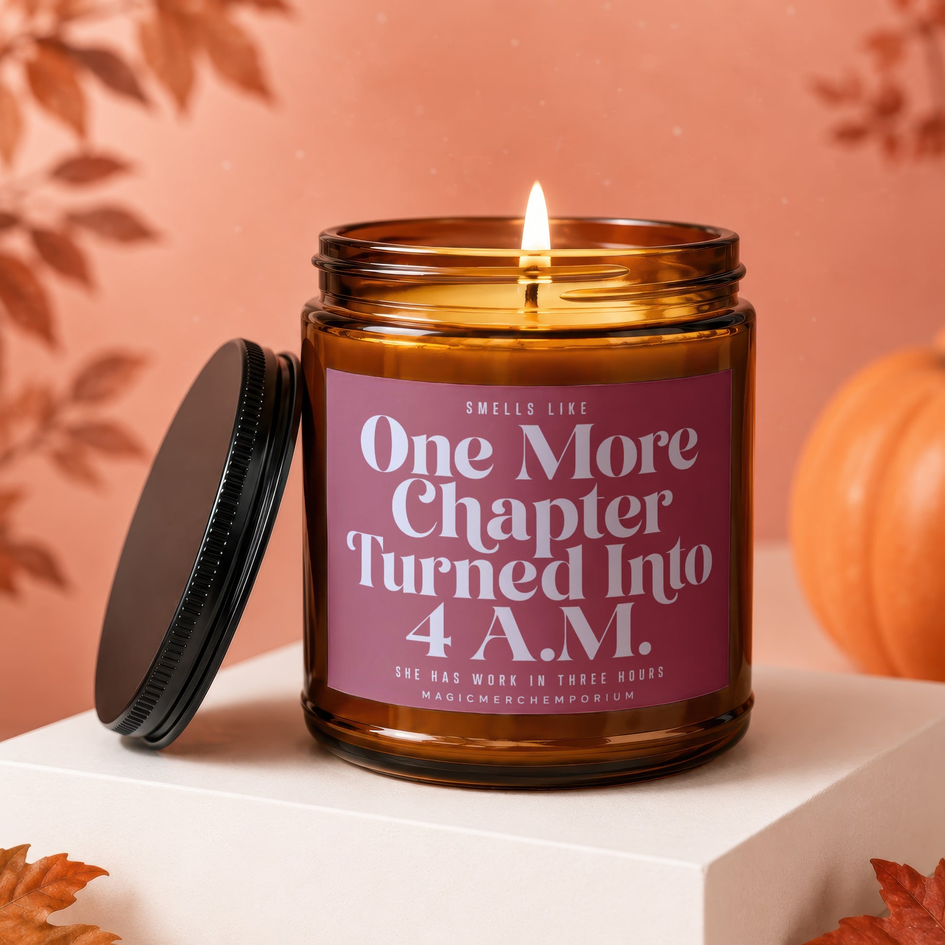 Amber jar candle with lit wick, reads "One More Chapter Turned Into 4 A.M."