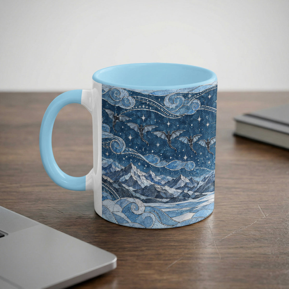 A light blue and white ceramic mug featuring a fantasy dragon and mountain mosaic illustration.