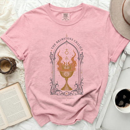Pink t-shirt with "The Brimstone Chalice" graphic and "Volcanic Alchemy" text.