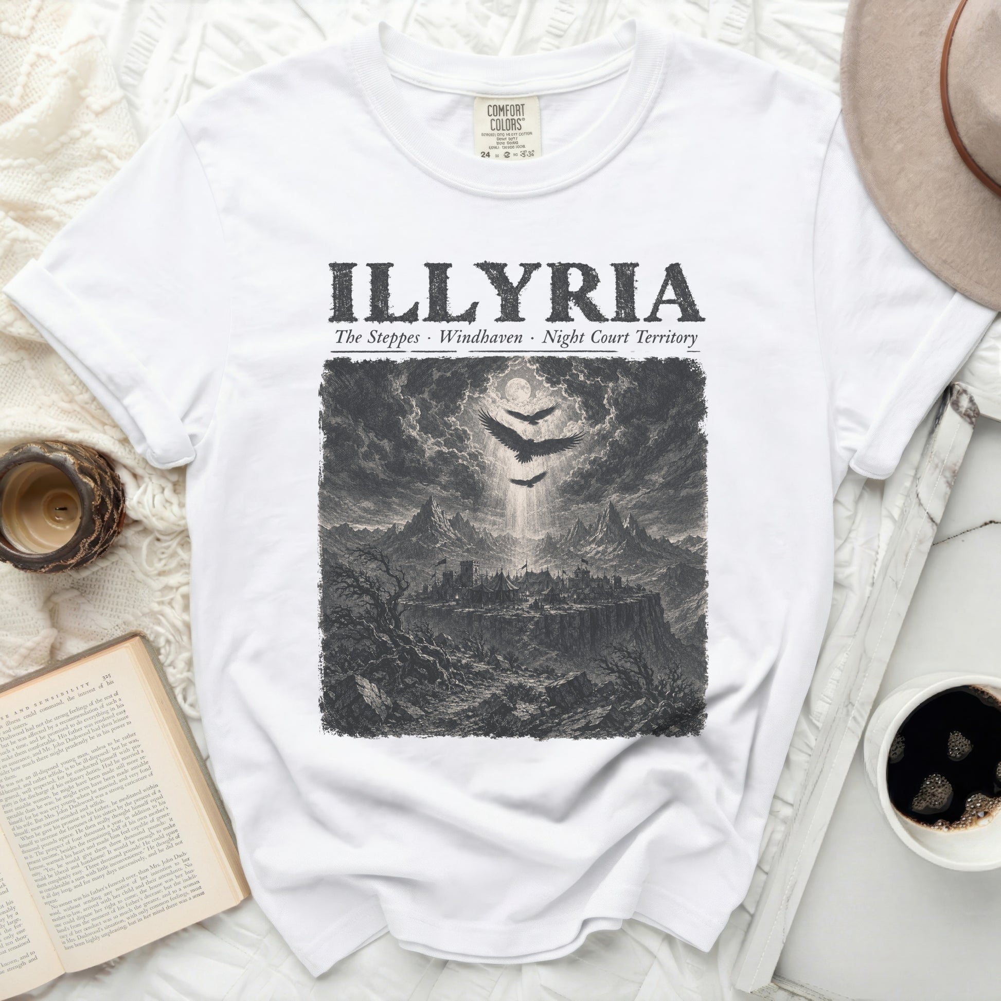White t-shirt with "ILLYRIA" text and a dark, detailed landscape illustration.
