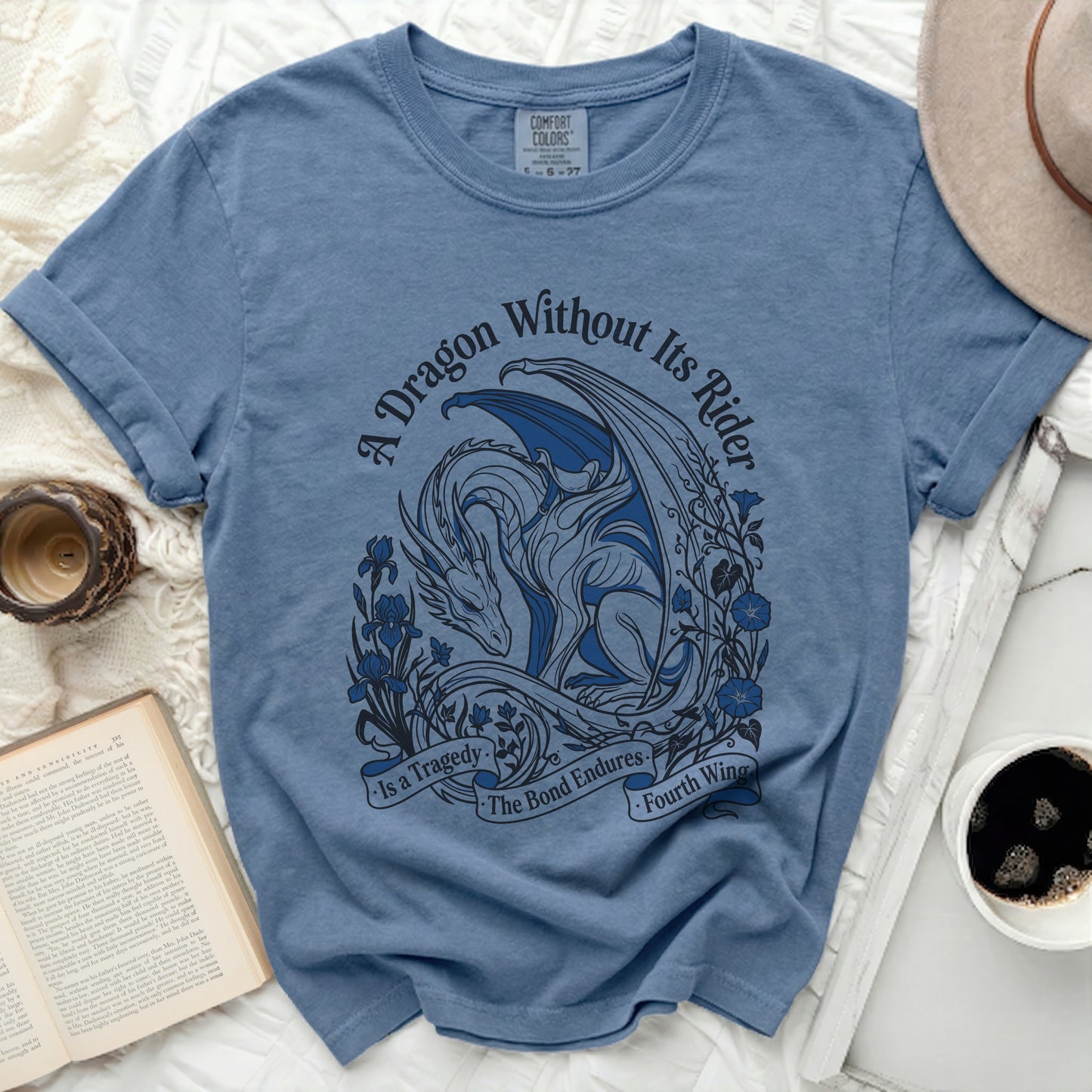 Blue t-shirt with dragon design and text "A Dragon Without Its Rider is a Tragedy. The Bond Endures. Fourth Wing."