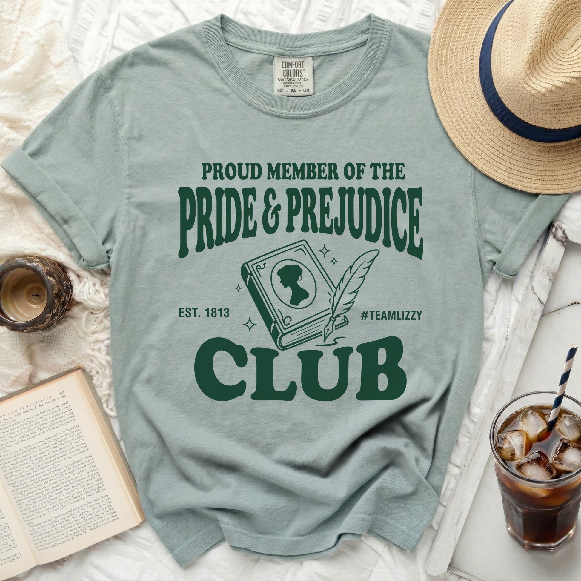 Green t-shirt with "Proud Member of the Pride & Prejudice Club" text.
