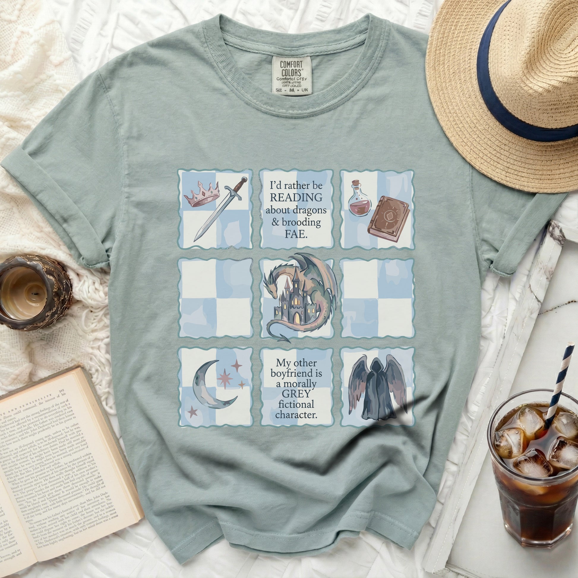 T-shirt with grid design featuring reading quotes, dragons, and fae motifs.
