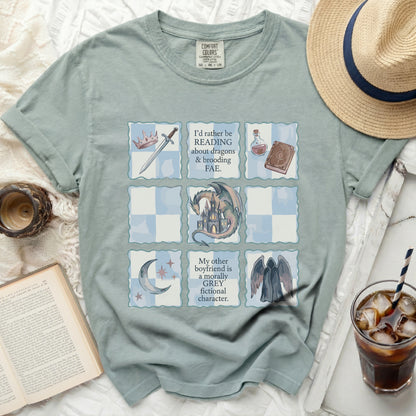 T-shirt with grid design featuring reading quotes, dragons, and fae motifs.