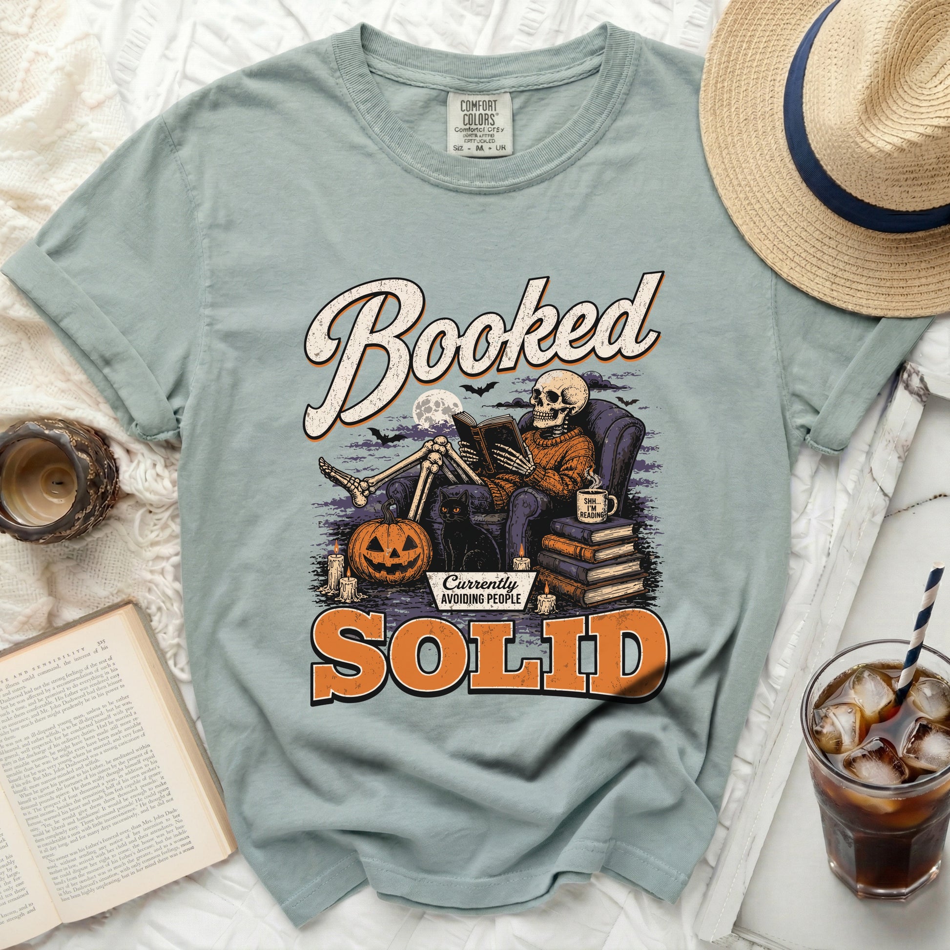 Skeleton reading a book with text "Booked" and "Currently Avoiding People Solid".
