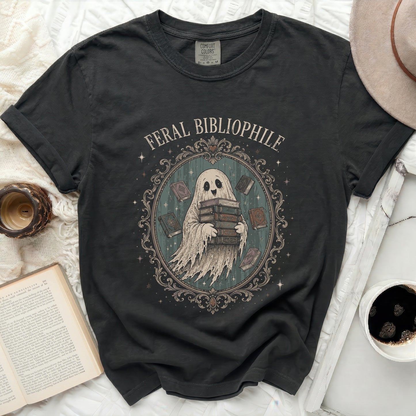 Feral Bibliophile ghost holding books design on a charcoal t-shirt.