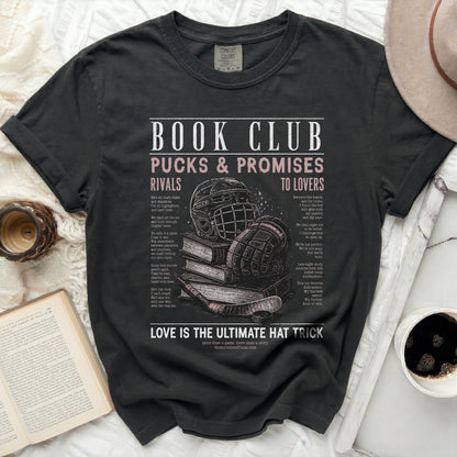 Black t-shirt with "Book Club Pucks & Promises" text and hockey equipment.
