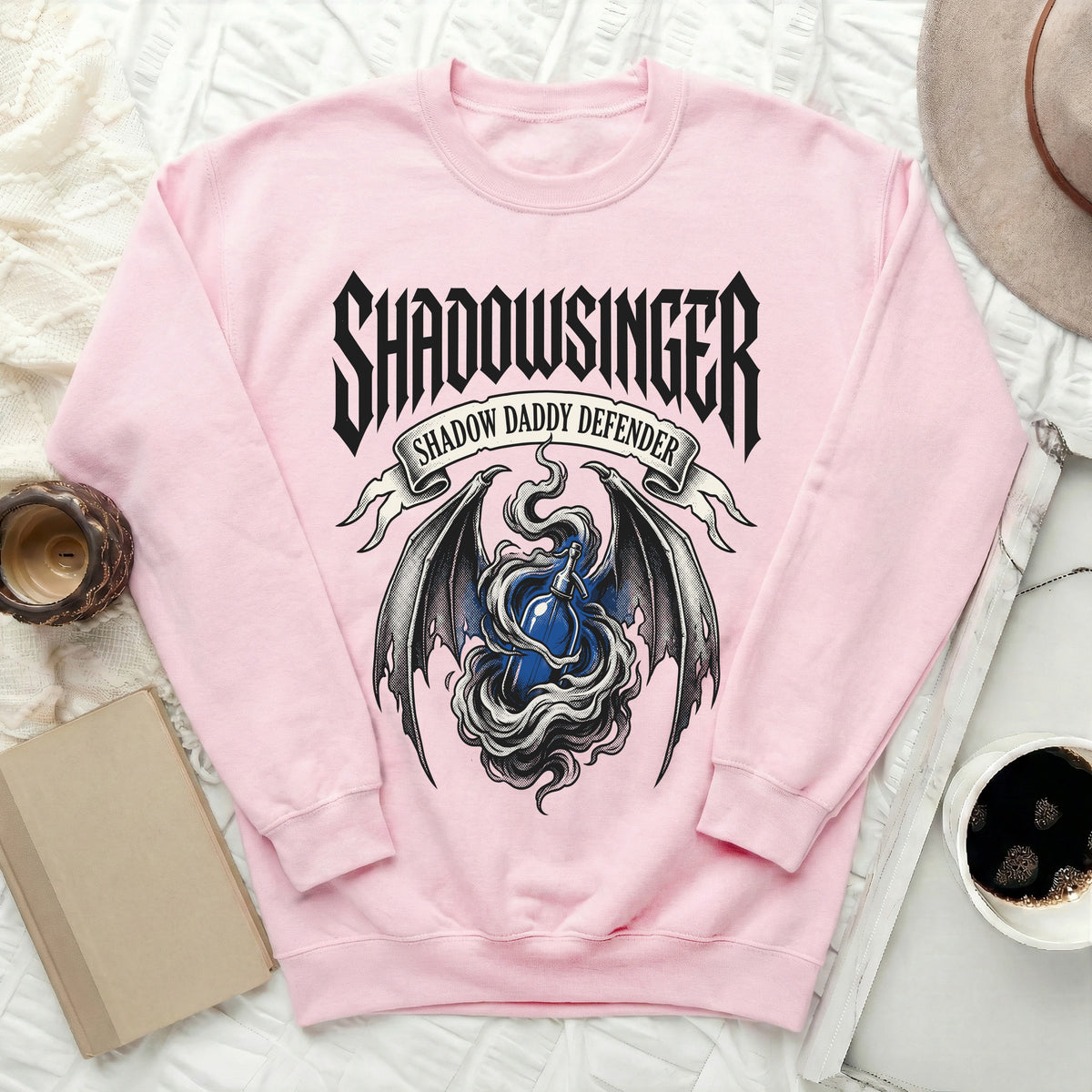 Pink sweatshirt with "SHADOWSINGER SHADOW DADDY DEFENDER" text and dragon wings.