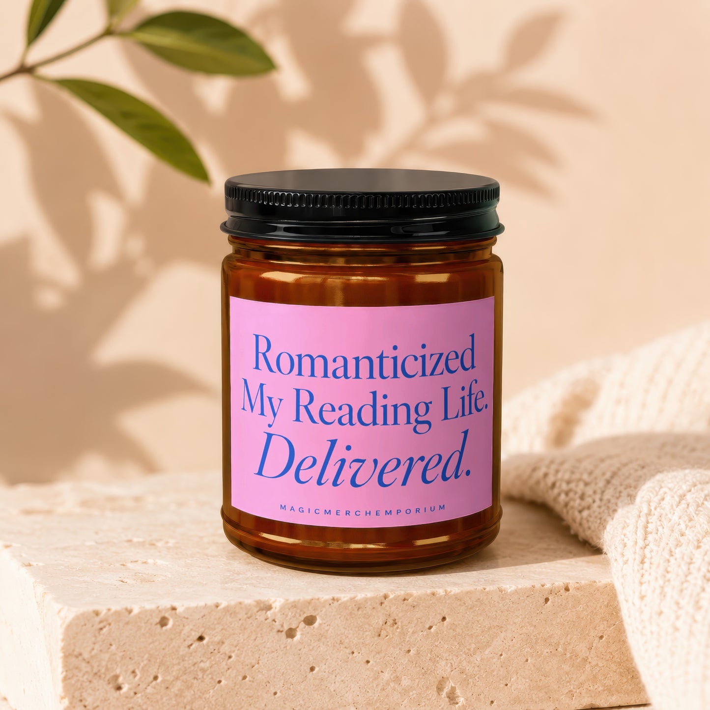 Amber candle with pink label reading "Romanticized My Reading Life Delivered. MAGICMERCH...".