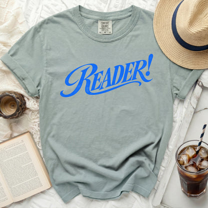 T-shirt with blue "READER!" text, straw, hat, and book.