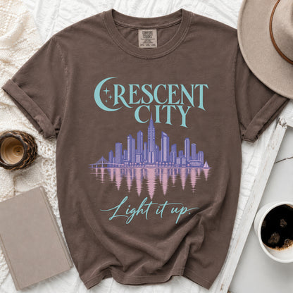 Brown t-shirt with "Crescent City" and skyline graphic, "Light it up" text.