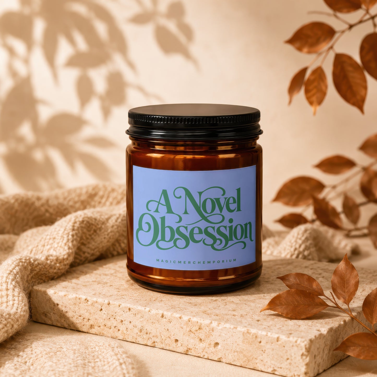 Brown amber jar candle with blue label reading "A Novel Obsession" and "MAGICMERCH_EMPORIUM".
