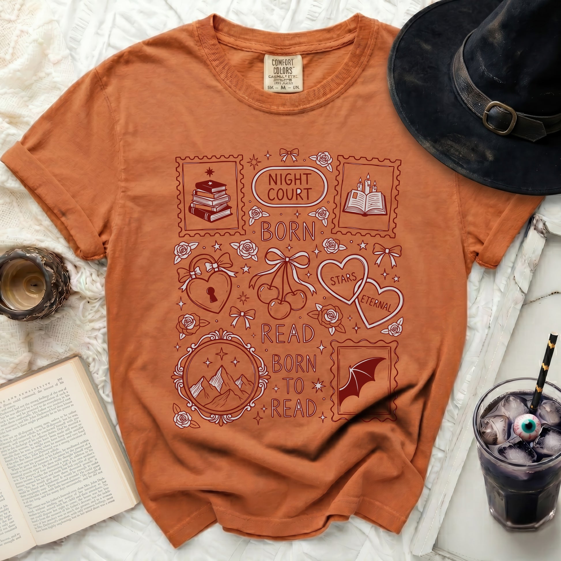 Orange t-shirt with "Night Court Born to Read" and book-themed stamp graphics.