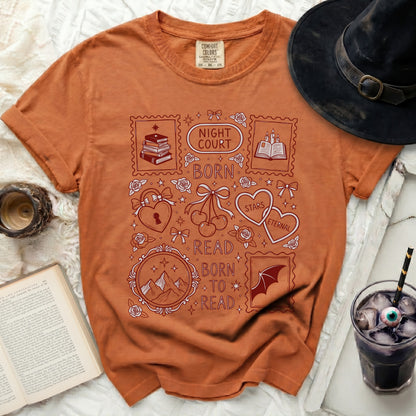 Orange t-shirt with "Night Court Born to Read" and book-themed stamp graphics.