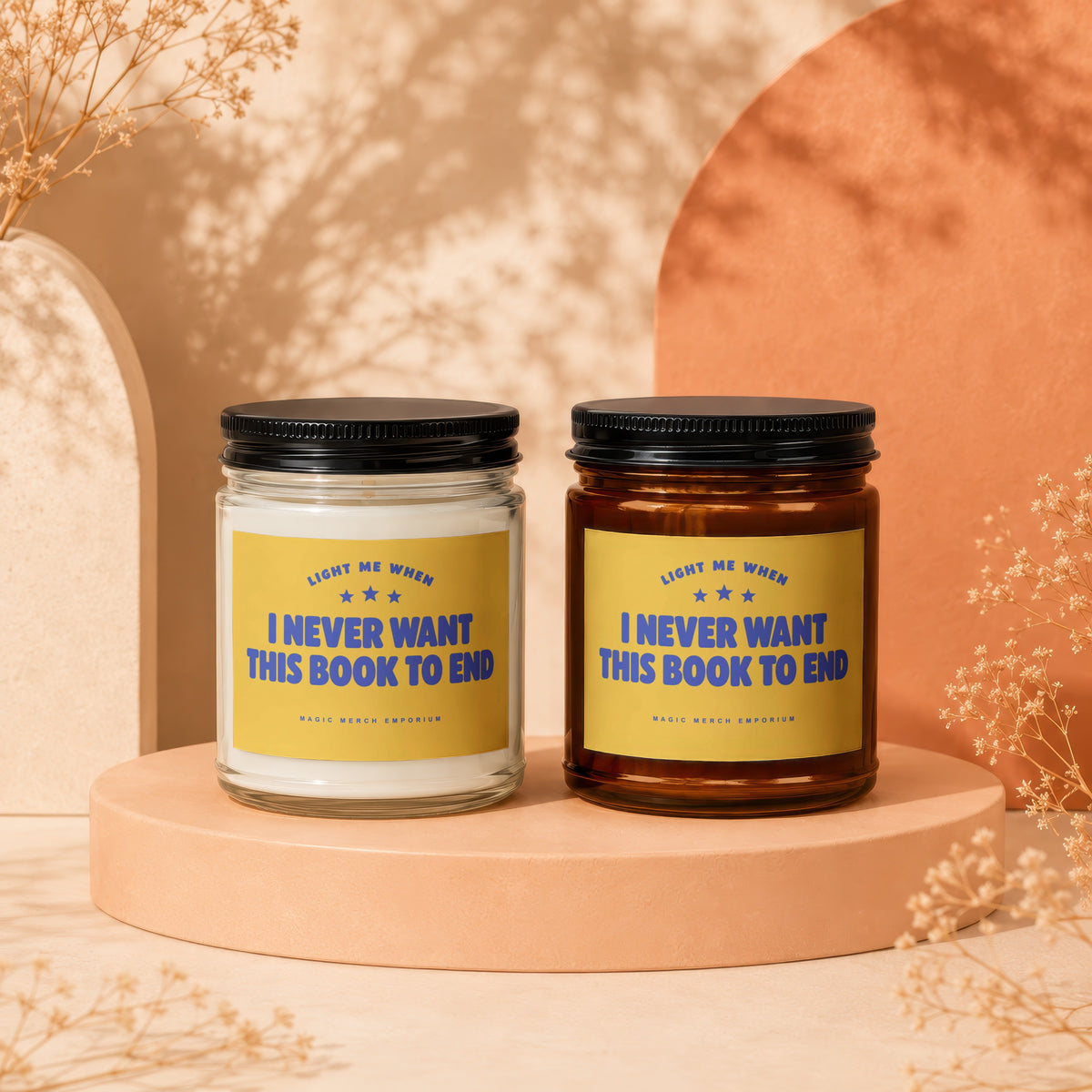 Two scented candles with yellow labels reading "I Never Want This Book To End".