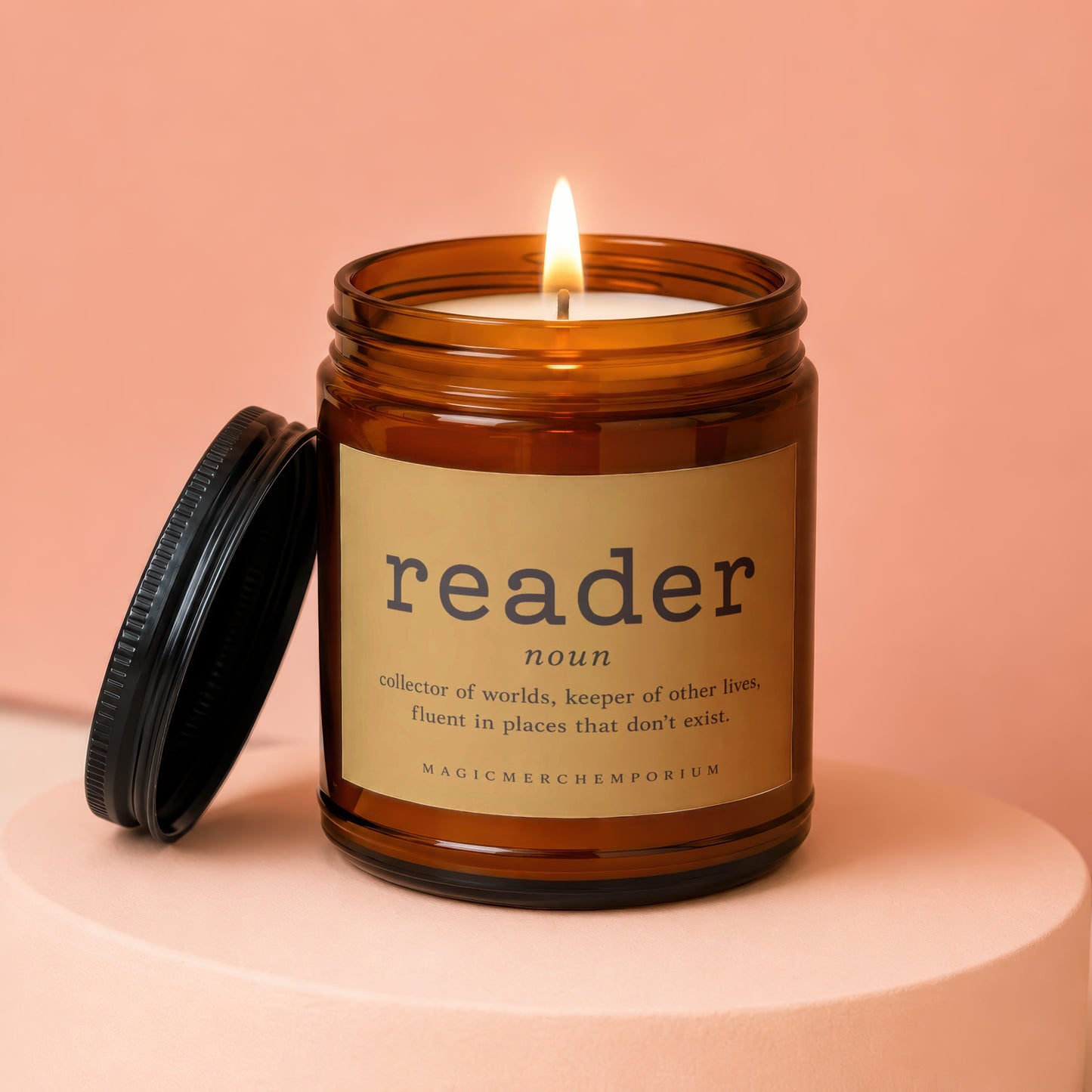 Candle with label reading "reader" and "collector of worlds, keeper of other lives".