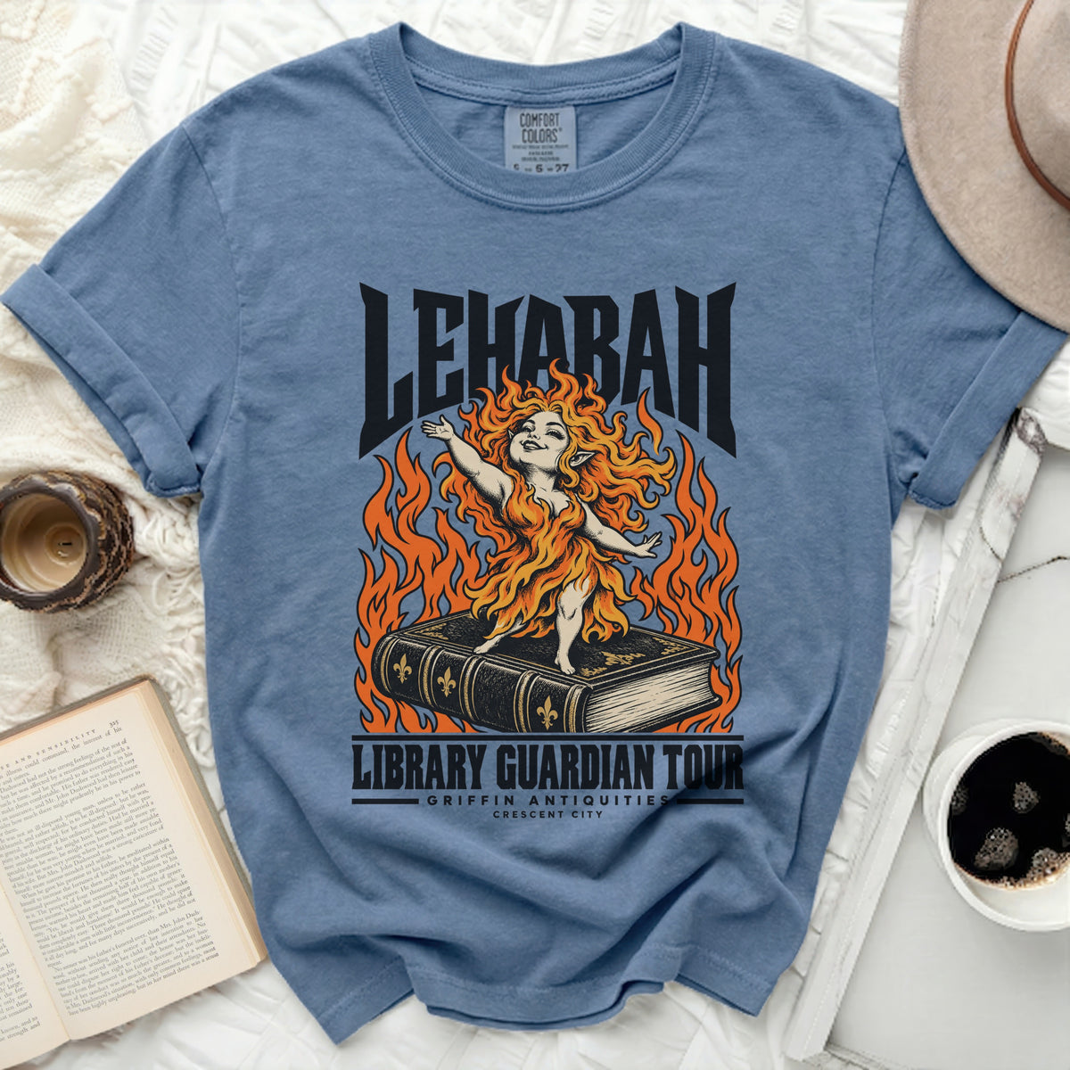 Blue t-shirt with "LEHABAH LIBRARY GUARDIAN TOUR" graphic of a fiery figure on a book.