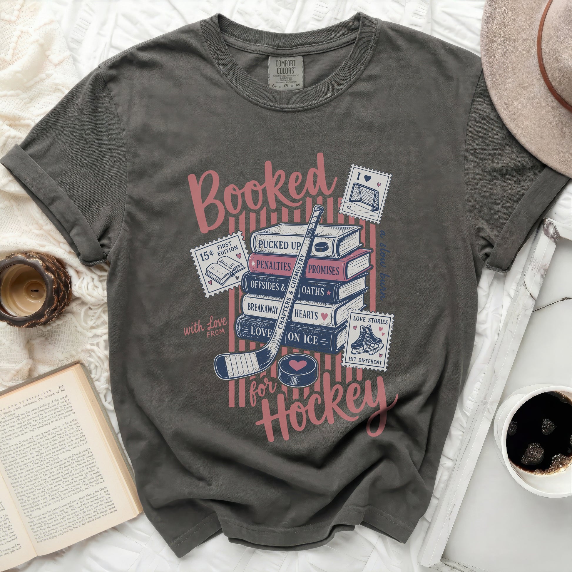 Gray t-shirt with "Booked for Hockey" in pink and blue text.