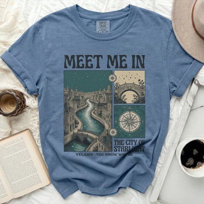 Blue t-shirt with "MEET ME IN VELARIS: THE CITY OF STARLIGHT" text and illustrations.