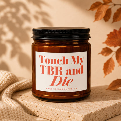Amber candle with black lid reads "Touch My TBR and Die" and "MagicMerchEmporium".