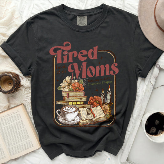 Tired Moms, coffee, books, and candles graphic on a Comfort Colors t-shirt.