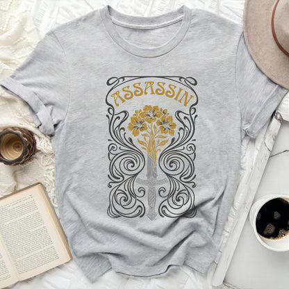 Grey t-shirt with ornate "ASSASSIN" text and floral sword design.